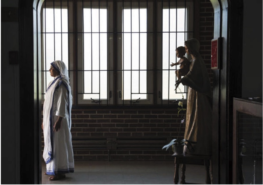 Sister Tanya, the superior for the Missionaries of Charity at the Gift of Peace convent in Washington, D.C., looks out the door on Aug. 31, 2016, days before Mother Teresa was canonized as a saint on Sept. 4, 2016. Photo: Nikki Kahn Washington Post
